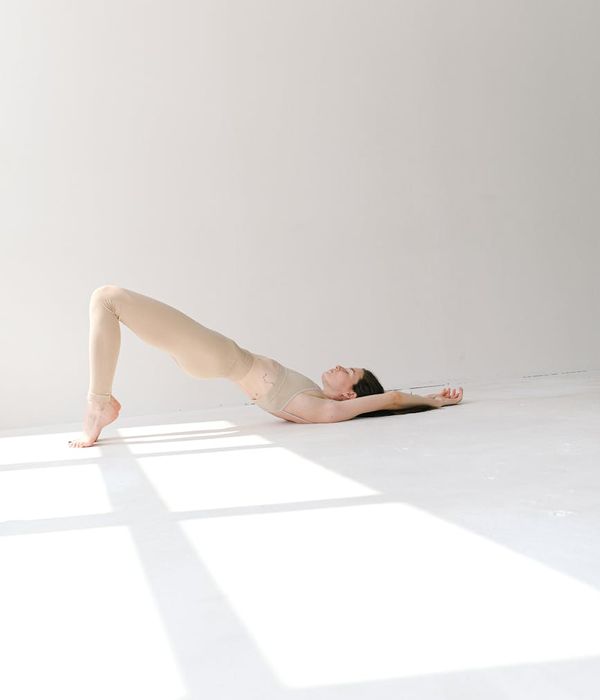 Woman in a graceful yoga pose with natural light background.